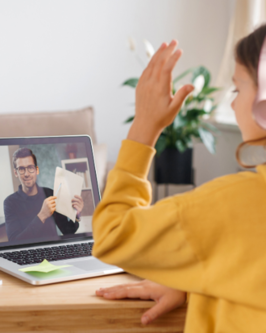 Student waving to their online tutor during a session