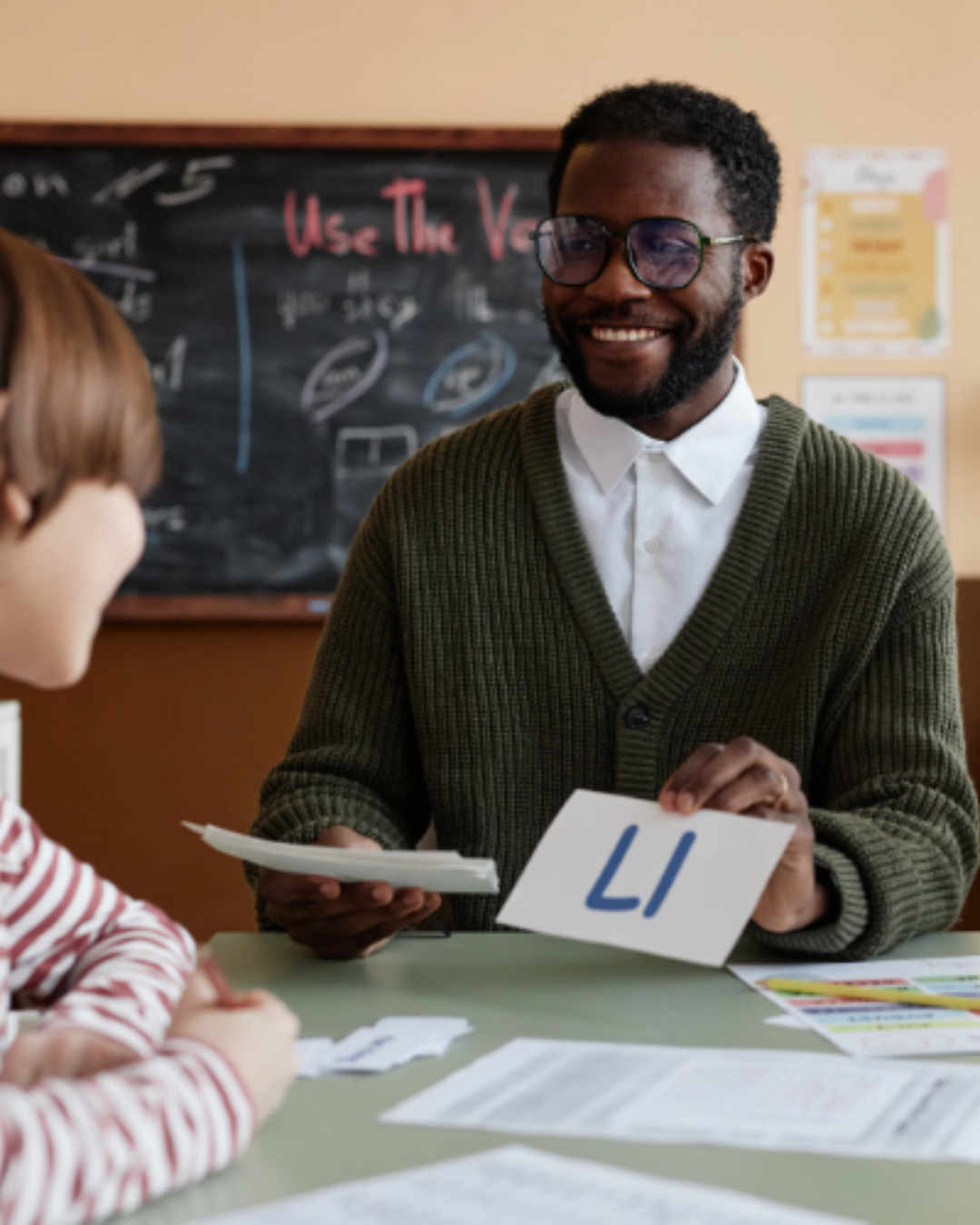 Teacher using letter flashcards with a student