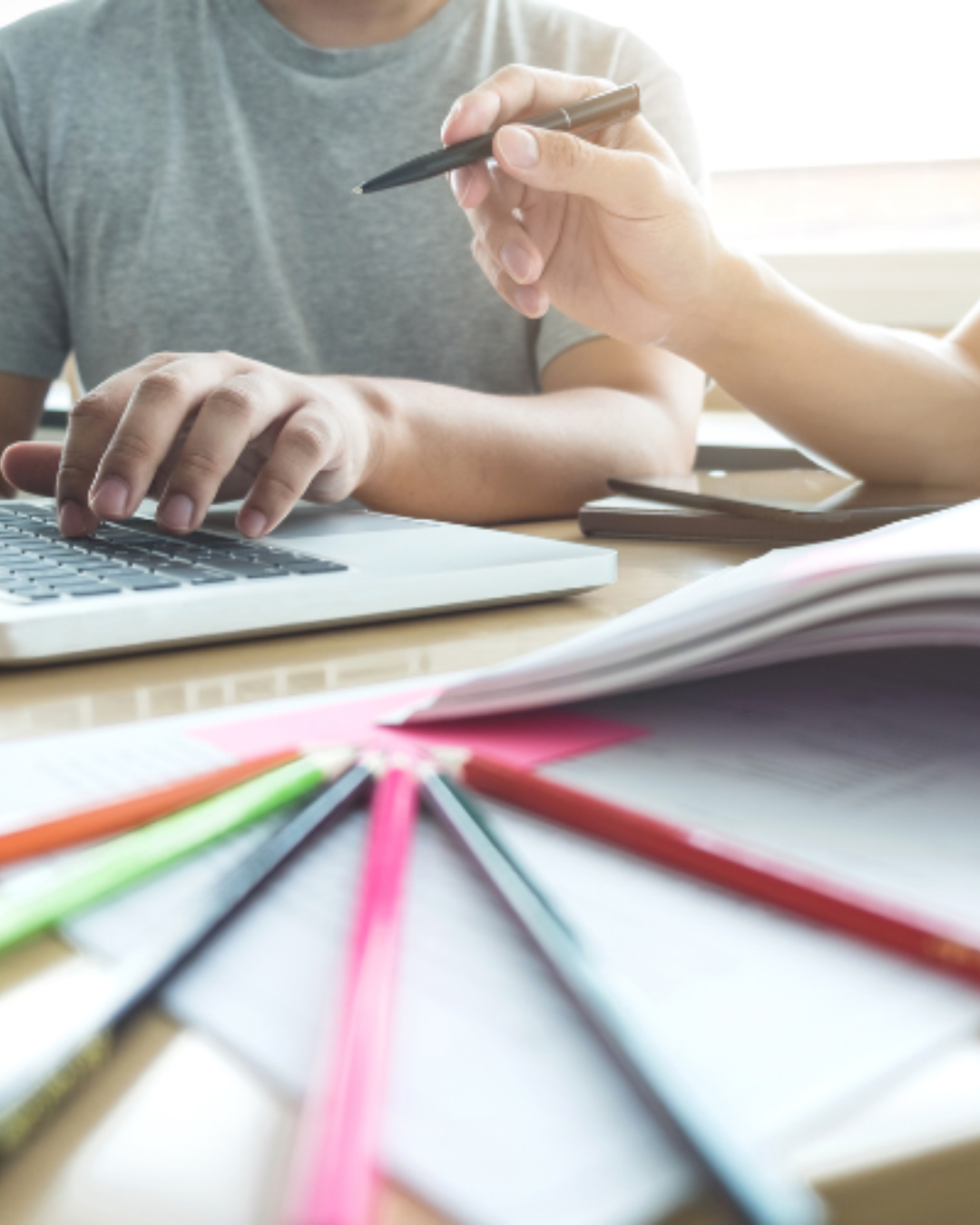 Planning a study schedule with notes and a laptop
