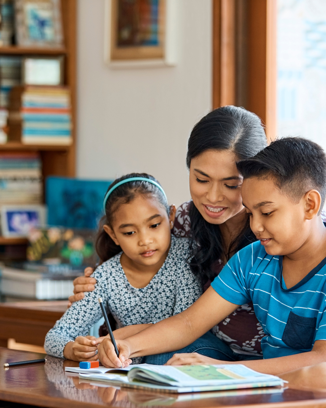 A parent reading a book with children on a cozy couch